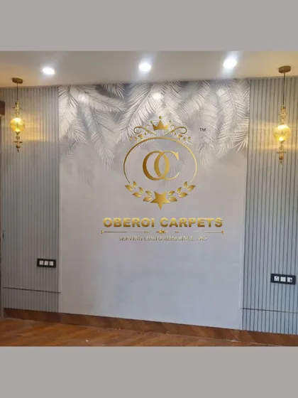 A subtle and elegant wall design featuring a light grey wallpaper with a silver palm leaf motif, complemented by matching fluted panels and classic pendant lights.