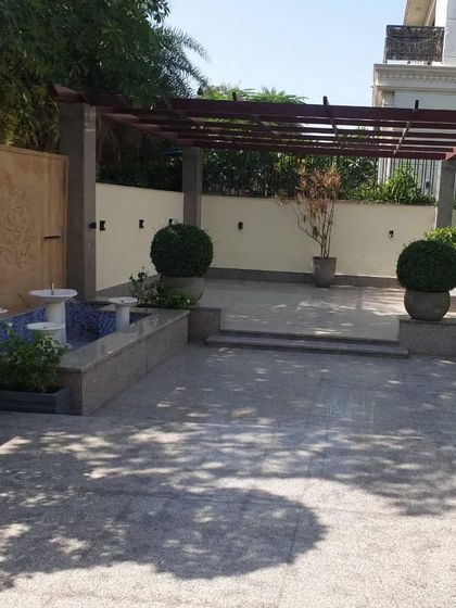 The patio and fountain area of a mini-farm project, showing how I integrate hardscaping elements like pergolas and water features.