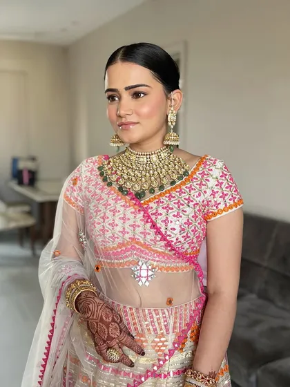 The complete look is a vision of elegance and grace. The soft makeup and sleek hairstyle create a timeless and sophisticated bridal style.
