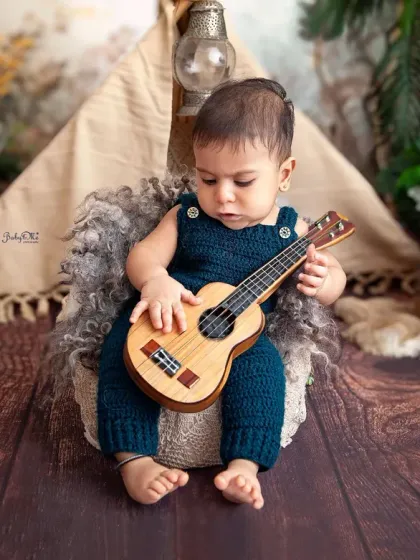 Deep in concentration, this little musician is creating a masterpiece. These candid moments are often the most precious ones from a sitter session.