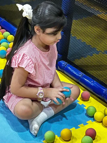 A quiet moment of play, sorting through the colorful balls in the pit.