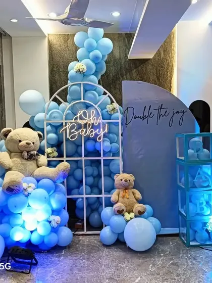 Here is a classic "It's a Boy" baby shower setup with a popular teddy bear theme. I combined a full balloon arrangement with custom props like the window arch, light-up 'BABY' blocks, and an 'Oh Baby' neon sign to create a fun and memorable corner.