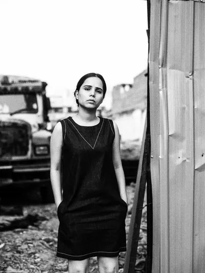 A portrait taken in an industrial setting. The rawness of the location complements the subject's direct and unflinching gaze, creating a beautifully honest image.