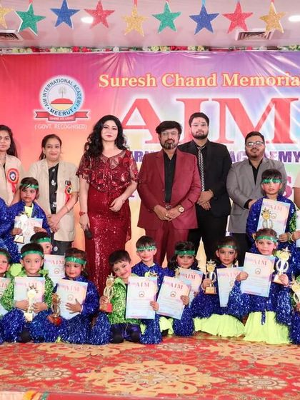 On stage with the talented young performers at the AIM International Academy's Annual Function. The enthusiasm of these students is a reminder that the future is bright.