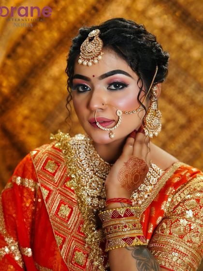 A confident and direct pose, showing the complete bridal makeup and jewelry.