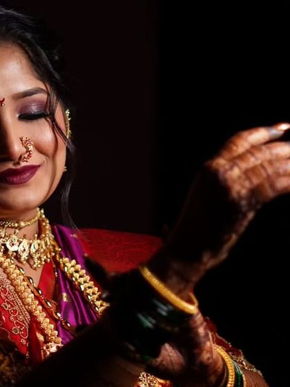 A dramatic close-up of the bride's makeup. The smokey eye and bold lip color are perfect for a traditional evening ceremony, ensuring she stands out.