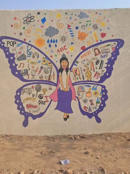 A butterfly girl mural with wings full of doodles representing different arts and sports, encouraging students to explore their passions.