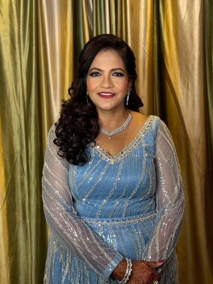 A full-smile moment from this happy client. Her cocktail party makeup features a bold lip and defined eyes, perfectly balanced for a festive occasion.