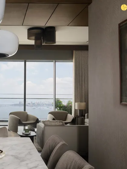 A view from the dining area into the living room at 'Pad by the Bay.' The open layout and consistent material palette create a sense of flow, while large windows connect the interior to the expansive sea and city skyline.