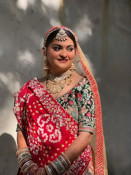 A full portrait of my Gujarati bride, showcasing her traditional bandhani saree and the radiant makeup that complements her vibrant look.