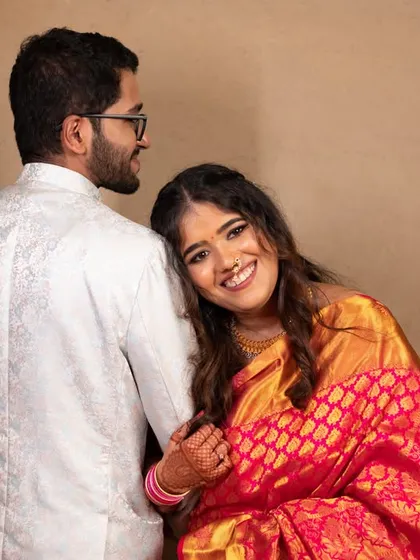 A cute and affectionate pose from a pre-wedding shoot. The bride leaning on the groom's back is a playful and intimate gesture.
