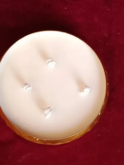 An overhead view of the golden hammered urli candle, showing the spiral wicks.