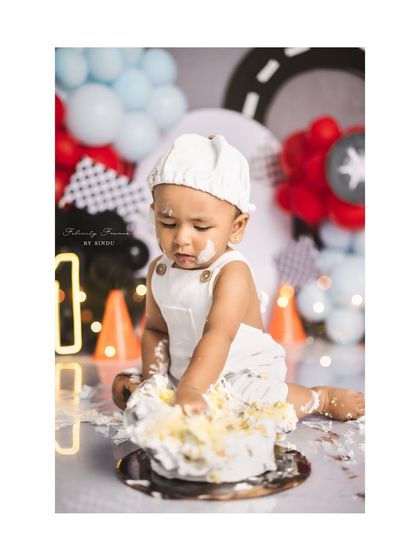 A messy and happy baby boy during his race car themed cake smash. He thoroughly enjoyed his first taste of birthday cake!