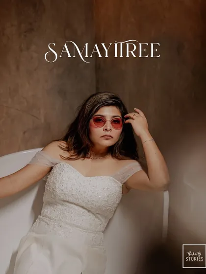 A chic and modern bridal portrait with an editorial feel. The unique pose in a bathtub with sunglasses shows a fun, confident personality.