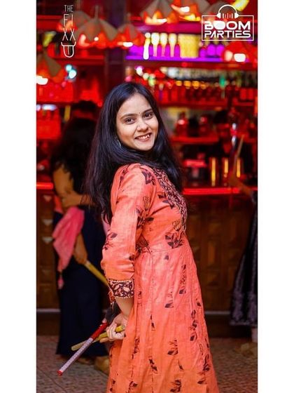 A guest with dandiya sticks at The Fixx.