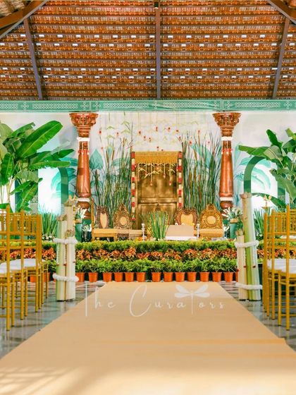A full view of our reimagined Muhurtham stage, set within a traditional hall. We used lush greenery and a custom backdrop to create a focal point that is both elegant and unique.