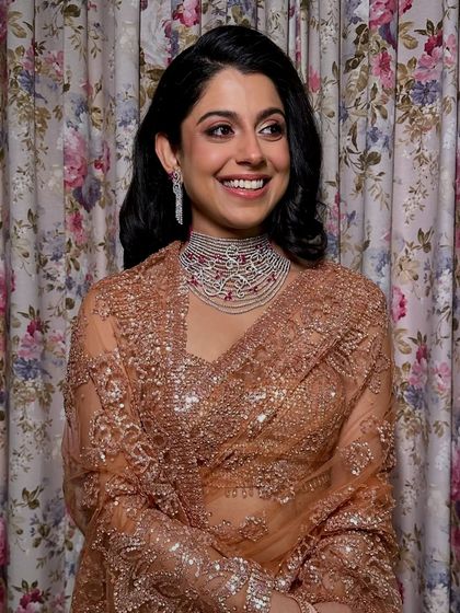 The perfect smile to complete a perfect look. Her soft yet striking glam was designed to complement her beautiful saree and diamond jewelry.