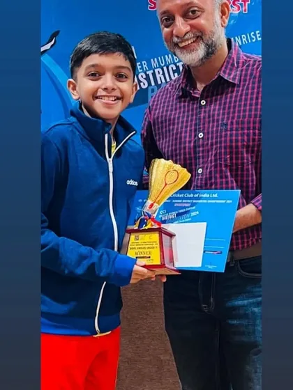 Adiraj Shetty receiving his winner's trophy for the BS U11 category at the CCI GMBA District Badminton Championship.