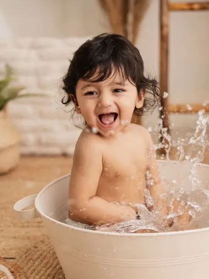 The pure joy of a warm bubble bath splash, the perfect and happy end to a fun first birthday photoshoot.