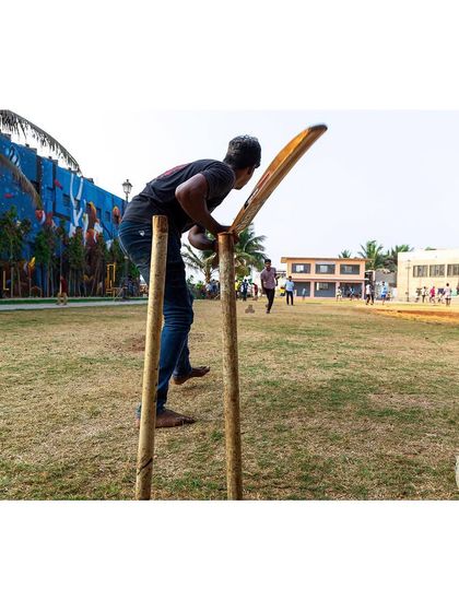 A makeshift wicket stands ready for a game of cricket, a common sight at the Gora Dabkal ground. The open, resilient lawn was designed specifically to support such beloved community sports and activities.