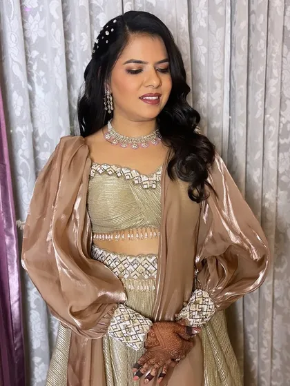 Bronzed perfection for this beautiful client. I created a warm, bronzy makeup look with a soft smoky eye that perfectly complements her earthy-toned outfit.