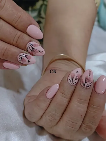 An example of my hand-painting skills. This design features delicate, translucent flowers painted on a soft pink base.