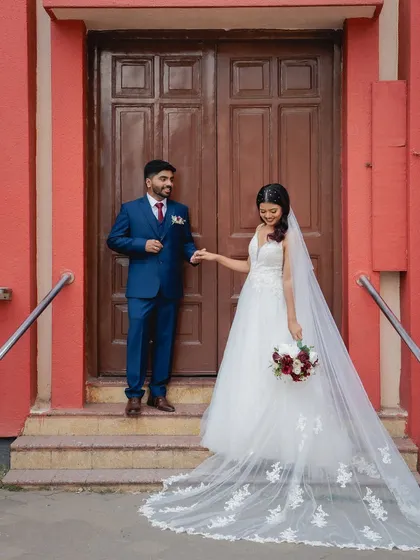 Another beautiful shot of the couple, showing the bride's elegant gown and veil. Her makeup is kept natural and radiant to let her happiness be the focus.
