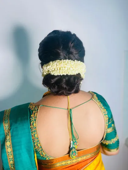 Another view of the timeless jasmine-adorned bun, a favorite for South Indian ceremonies.