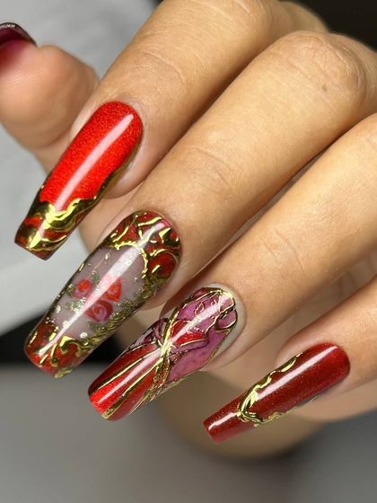 A dramatic and luxurious set of extra-long square extensions. The design features a deep red base with intricate, stained-glass-style gold and floral details.