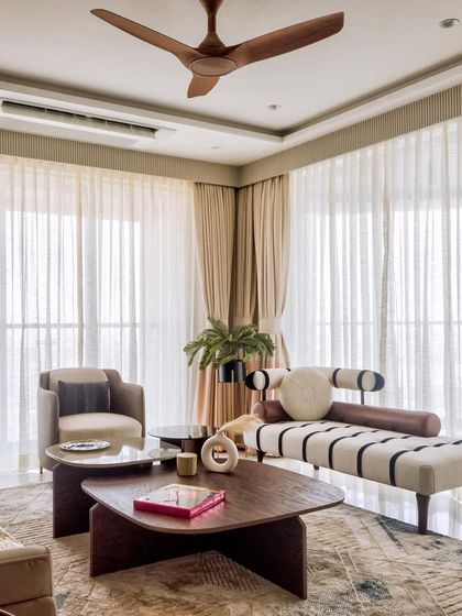 A closer look at the lounge area in the 'Urban Tranquility' project. The striped chaise lounge and organically shaped coffee tables add a touch of modern artistry to the room.