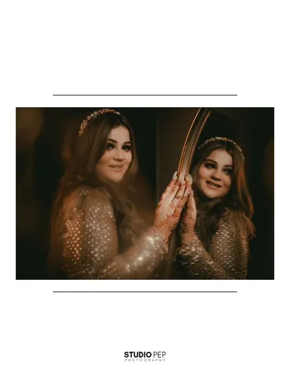 A close-up of Gurbani's reflection, her hand gently touching the mirror, creating an intimate and thoughtful portrait.