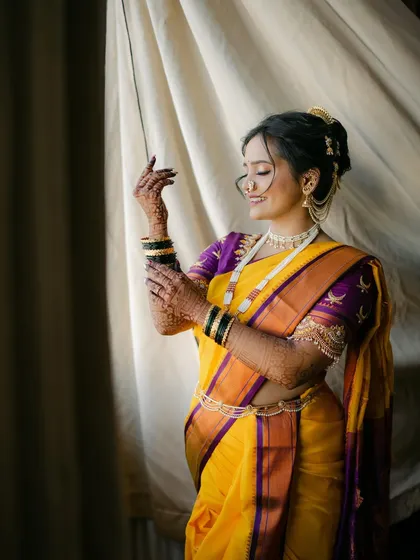 A graceful portrait. The soft makeup and elegant nauvari drape create a look that is both classic and stunning.