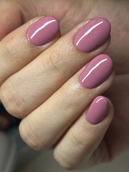 A lovely mauve-pink solid color manicure. This shade is a perfect balance between a neutral and a pop of color, suitable for any occasion.