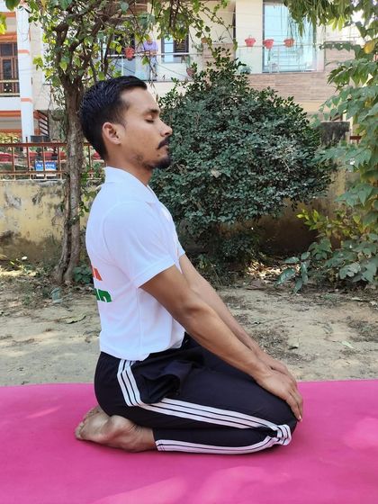 This is Vajrasana, or the Thunderbolt Pose. It is one of the few asanas that can be practiced after meals as it aids digestion and can help alleviate abdominal pain by improving blood flow to the digestive organs.