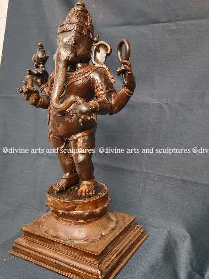 This is the wax model of a standing Ganesha. The dark wax allows us to sculpt very fine details, like the patterns on his crown and the items in his hands, before casting.