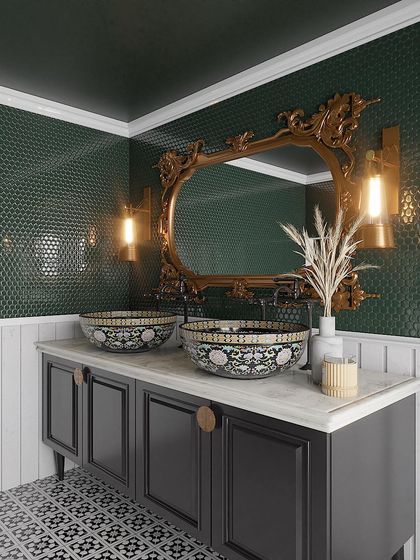 A retro-revival bathroom featuring bold green penny tiles, an ornate gold mirror, and intricately patterned ceramic sinks for a vintage vibe.