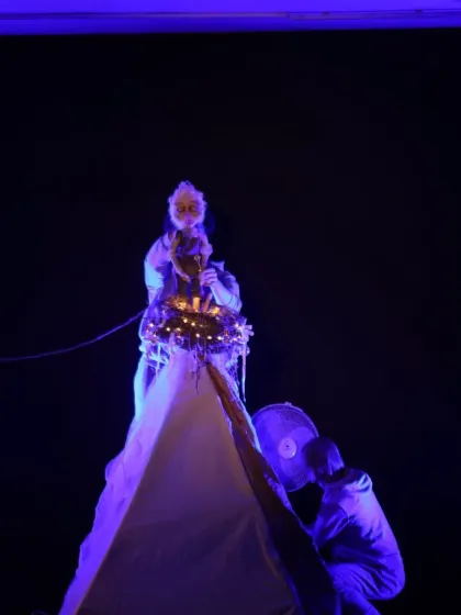 A dramatic, blue-lit scene from 'Sea of Possibilities'. The use of lighting and live projection adds a cinematic quality to the performance.
