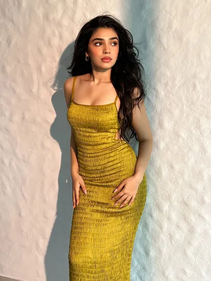 A behind-the-scenes shot of Krithi Shetty in this simple yet chic yellow summer dress. This shows that sometimes, a great fit and a pop of color are all you need.