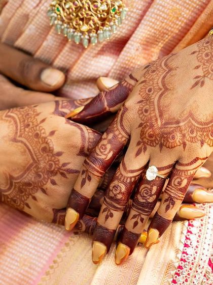 A beautiful close-up of a mature henna stain. The deep color provides a stunning contrast against the bride's skin and her traditional bangles.