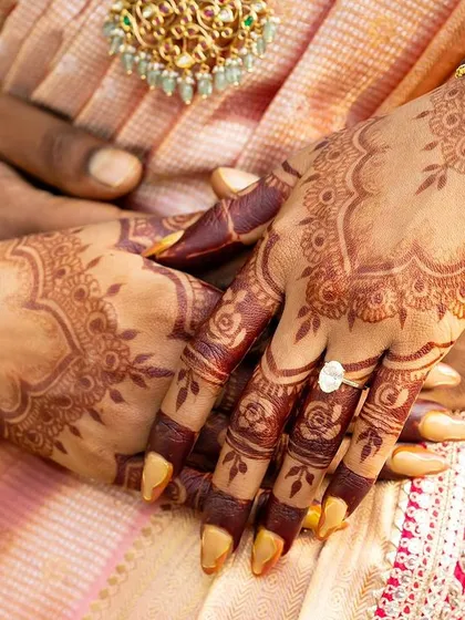 A beautiful close-up of a mature henna stain. The deep color provides a stunning contrast against the bride's skin and her traditional bangles.