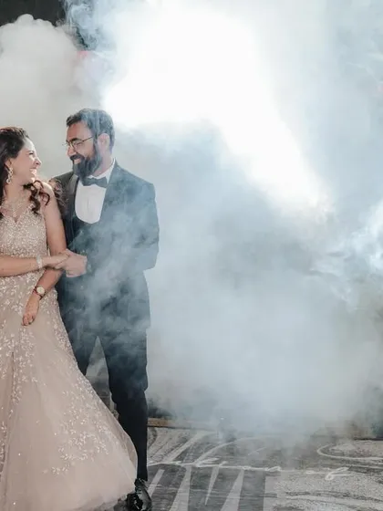 A dramatic and romantic shot from a cocktail night in Khajuraho. The smoke and backlighting create a magical, cinematic feel for the couple's first dance as husband and wife.