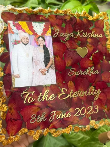 An 8-inch agate-style resin frame filled with preserved red rose petals. The design includes a wedding photo and custom golden text.