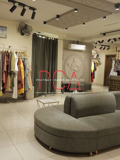 Another view of the client seating area, showing its relationship to the clothing racks and the Nataraja mural.