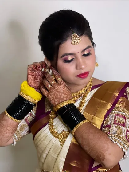 A beautiful bride getting ready for her Muhurtham. This shot captures the rich colours of her makeup and the intricate details of her temple jewellery.