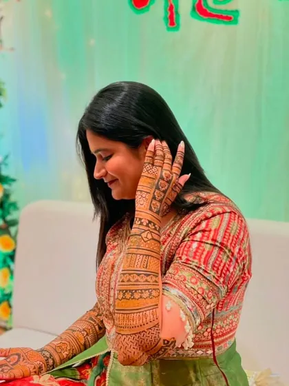 A candid shot of a client admiring her mehndi during her ceremony.