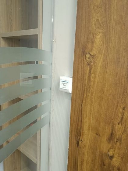 The small, white exit button is placed conveniently next to the door frame, allowing for easy departure from the gym.