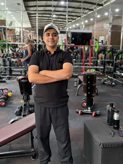 In a well-equipped gym, ready to coach.