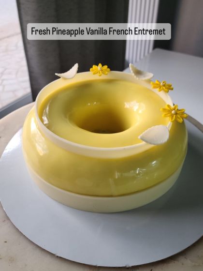 My Fresh Pineapple Vanilla French Entremet is a tropical dream. I infuse a fresh pineapple compote with star anise and pair it with a light vanilla mousse and soft vanilla sponge. It is finished with handcrafted chocolate feathers and edible flowers.