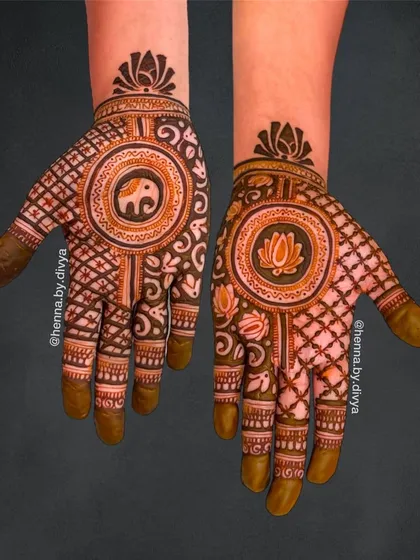 A creative design with different mandalas on each hand, one with an elephant and the other with a lotus. The palms are filled with contrasting grid and wave patterns for a unique look.