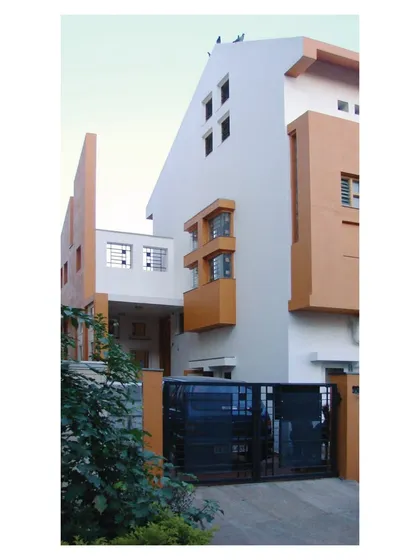 A close-up view of the entrance and connecting bridge at 'Nachiar Illam'. This detail shows how we create unique spatial experiences and circulation paths within our residential designs.